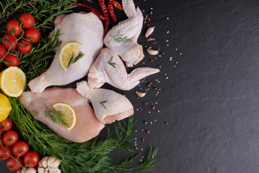 raw-chicken-fillet-with-garlic-pepper-rosemary-wooden-chopping-board